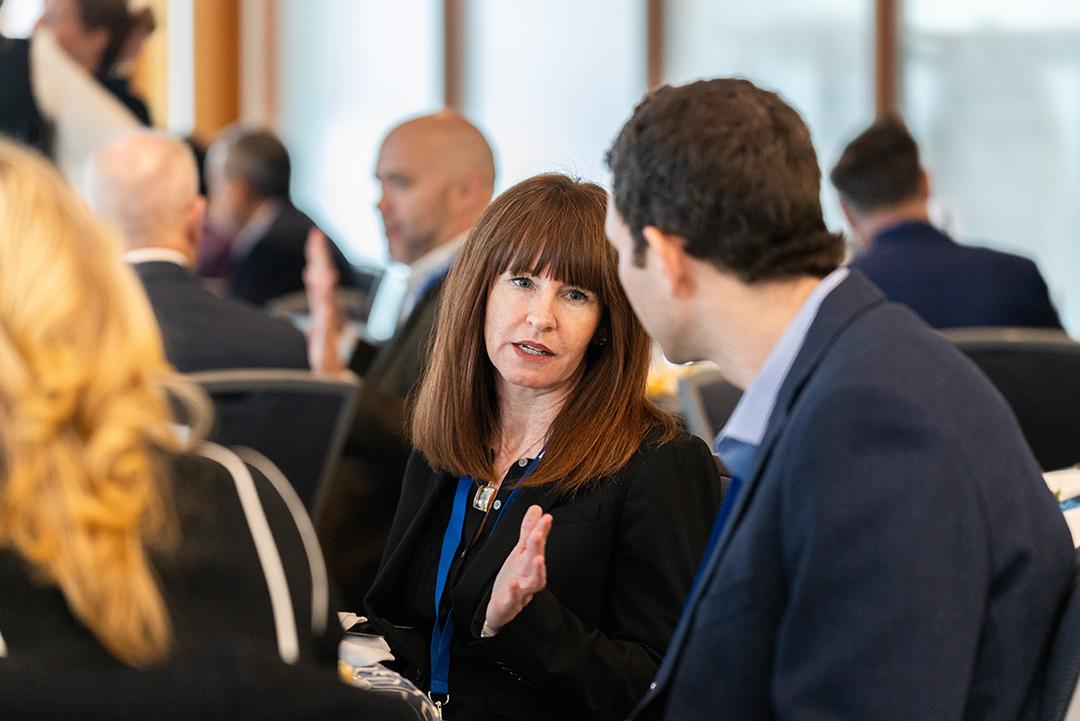 Conference attendees chat amongst themselves